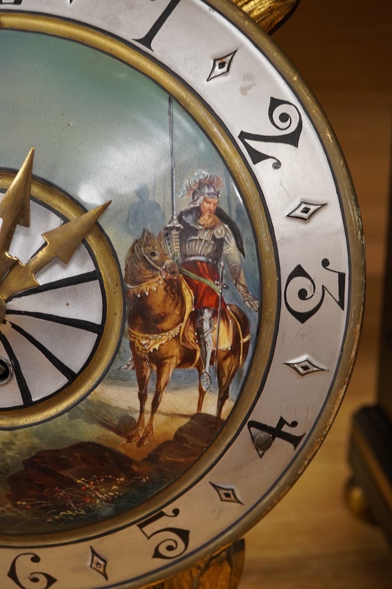 A Regency ebonised and brass inlaid lancet-shape bracket clock, with key and a painted pottery strut timepiece, largest 55cm high (2)